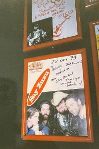 Two frames promotional band photos with handwritten signatures. The portrait of Say Zuzu includes the date written in Italian: October 22, 1998.