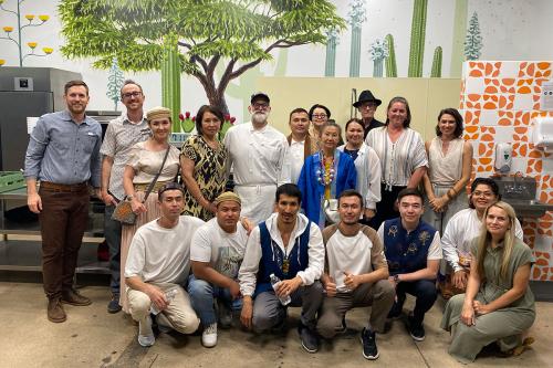 The Kazakhstan Artisan Initiative learning exchange group stands with chef Devon Sanner, one of Tucson’s culinary leaders, and others during their visit at the Catalyst Creative Collective.