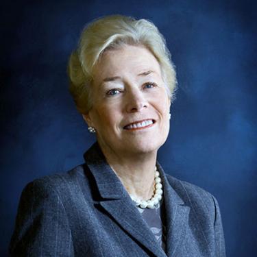 Headshot of Dorothy McSweeny in gray suit and pearl necklace.