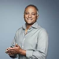 Headshot of Rohit Agarwal wearing a gray dress shirt and smiling.