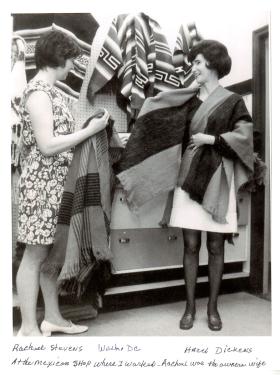 Two women in a store, holding and wearing woven shawls. Handwritten text below the photo labels Rachael Stevens on the left, Hazel Dickens on the left. It reads, “Wash. DC / At the Mexican shop where I worked - Rachael was the owners wife.”