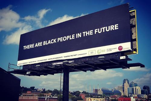 Billboard with white text on plain blue background: THERE ARE BLACK PEOPLE IN THE FUTURE.