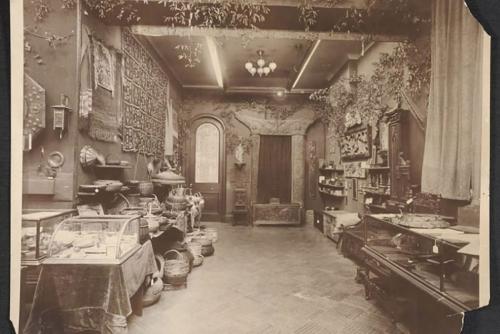 A sepia toned photograph of a room covered in vines filled with an assortment of craft products.