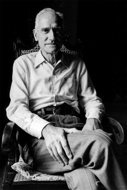 Black-and-white photo of Antoni Maria Badia i Margarit seated in a chair, legs crossed