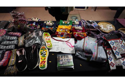 A merch table full of CDs, textiles, and small crafts.