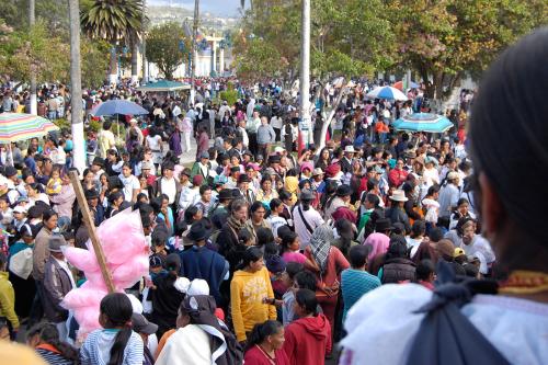 A crowd of people standing shoulder to shoulder outside.