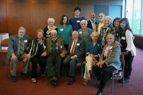 Several seniors and young adults posing together.