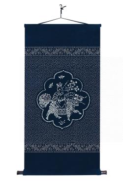 Rectangular calico wall-hanging, with a design of a person riding a mythical animal.