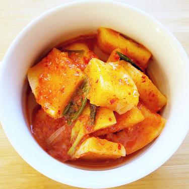 Bowl of chopped root vegetable in red broth.