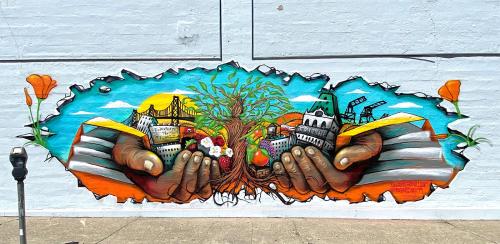 Mural that appears as a large hole broken through a white wall, revealing two Black hands holding up iconic buildings from Oakland, California, with a twisting tree in the middle. Orange poppies pop through the sides of the hole.