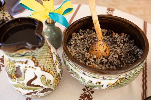 Ceramic dishes containing a dark liquid and a grain pudding.