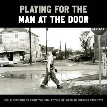 Album art for Playing For the Man at the Door, with a black and white photo of a man crossing a dirt road.