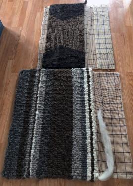 Two unfinished saddle pads, with the mesh grid still exposed on one side.