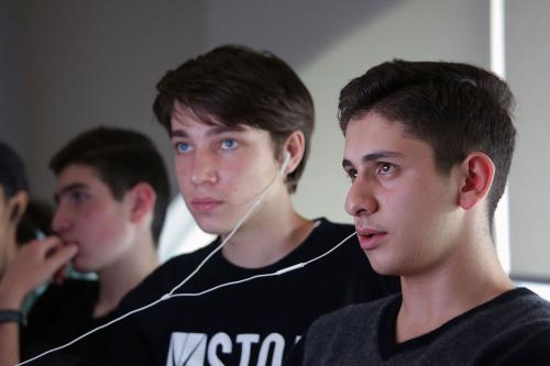 Teens work intently on computers.