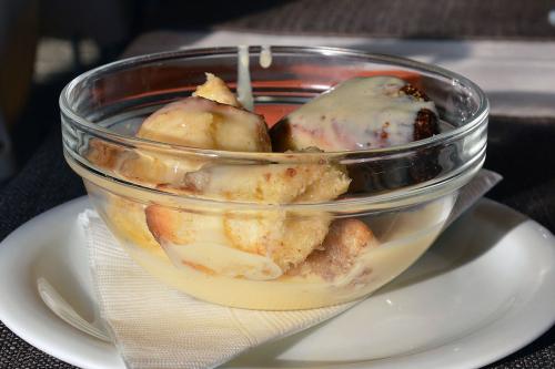 Close-up on a clear glass bowl with a few chunks of monkey bread.