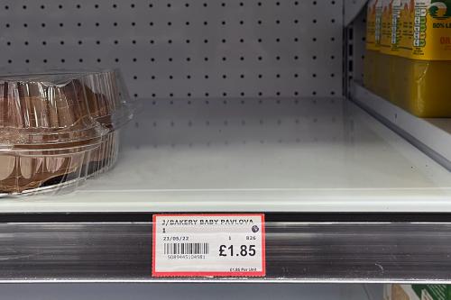 An empty spot in a grocery store shelf. The label below reads Bakery Baby Pavlova. 1.85 pounds.