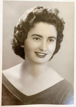 Black-and-white portrait of a woman with short curly hair.