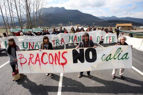 Protestors block a road with a banner that reads “Bracons no calia”—“Bracons was not necessary.”
