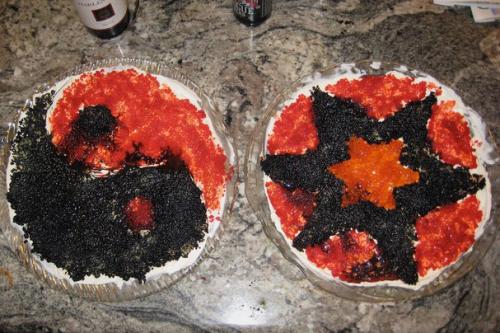 Two circular dishes of red and black caviar, arranged to look like a yin yang symbol and a Star of David.