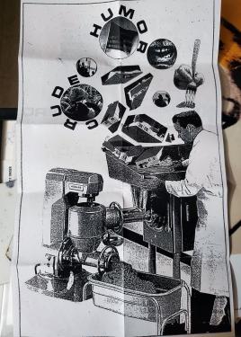 Xeroxed flyer, with an collaged illustration of a man in a lab coat operating a machine, which appears to be grinding tract homes, and American flag, and other suburban iconography into a pulp. The words CRUDE HUMOR circle two of the items about to be gro