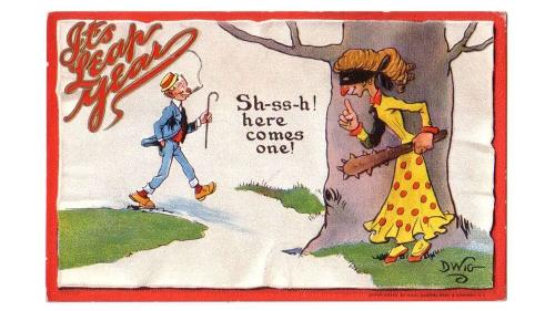 Illustrated postcard of a woman in a black robber's mask carrying a spiky club, hiding behind a tree as a man passes by. Words read, Sh-ss-h! Here comes one! In the top right corner in red script, It's Leap Year.