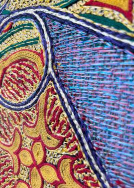 Even closer-up detail of the horses, revealing intricate patterns in red, yellow, and blue.
