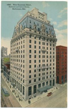 Tinted photograph of a 12+ story gray and blue building on a street corner. Small text: New Emerson Hotel, Baltimore and Calvert Streets, Baltimore, Maryland.