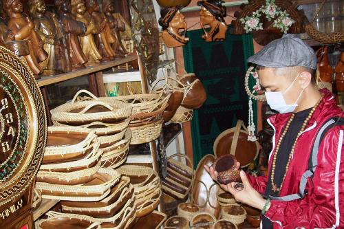 On the left, hat made from half of a dried brown gourd, with a brown cord strap. On the right, old photo  of a kid wearing a brimmed hat.