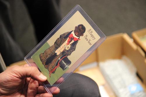 Laminated card showing a Black man and the message “A Happy New Year”.
