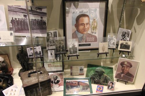 Museum display case showing photos and paraphernalia of African American military.