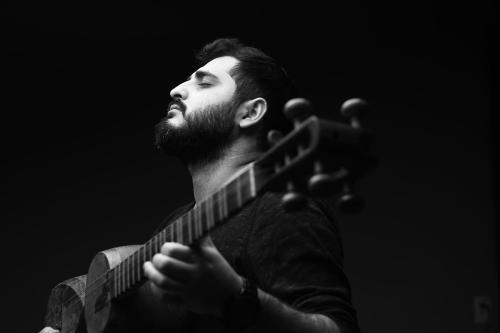 A man playing a stringed lute.