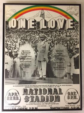 Old concert poster with Emperor Haile Selassie in front of a crowd, with the words ONE LOVE, at National Stadium, with a rainbow of red, yellow, and green.