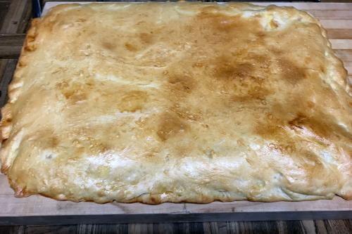 A rectangular slab-pie-like bread loaf, baked until golden brown on top.