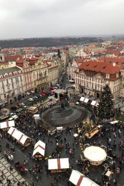 Aerial view of an outdoor market with tents set up in a city plaza.