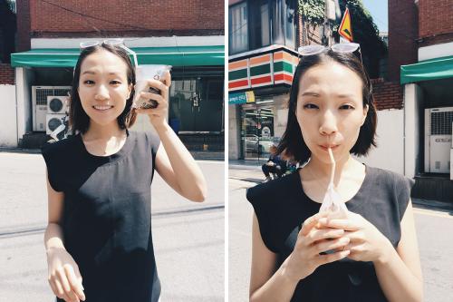 In two photos side by side, a woman holds up a triangular plastic container of coffee and then drinks it via straw, with a Korean 7-11 in the background.