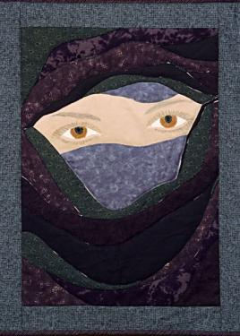 Art quilt with a design of a woman's eyes peeking through a dark-colored veil, like a burqa.