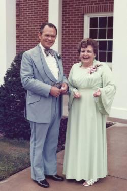 Old black-and-white photo of a couple in formal wear.