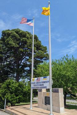 Vertical view of the stone monument, showing full height of the two flag poles.