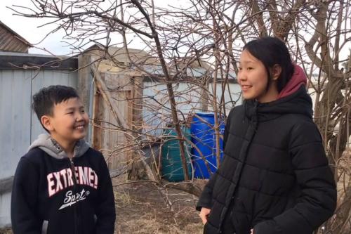 two children, a boy interviewing a girl