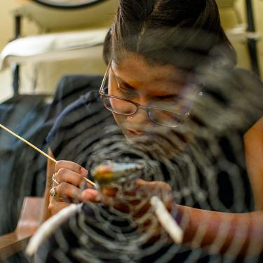 Working in clay, Tibetan bronze sculptor and Lag Zo participant Nima puts the finishing touches on Buddha’s face. Photo by Dawa Drolma, Smithsonian
