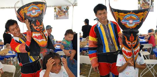 Wirayut Natsaengsri helps a young Folklife Festival visitor try on one of his masks. Photos by Nancy Libson, Ralph Rinzler Folklife Archives