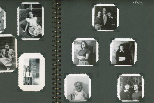 A spread in a photo album with black pages and small black-and-white portraits of people mounted inside.