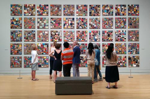 The team from the Royal Textile Academy in Bhutan tours the George Washington University Textile Museum with curator Lee Talbot. Photo by Jake Naughton