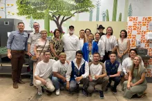 The Kazakhstan Artisan Initiative learning exchange group stands with chef Devon Sanner, one of Tucson’s culinary leaders, and others during their visit at the Catalyst Creative Collective.